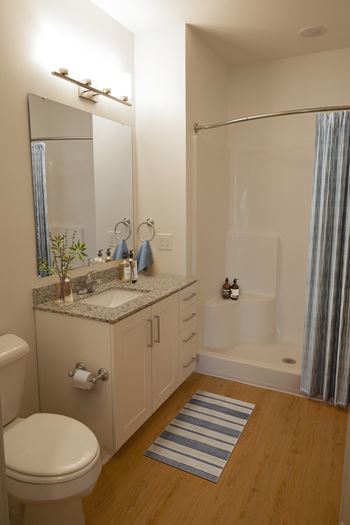 a small bathroom with a sink toilet and shower